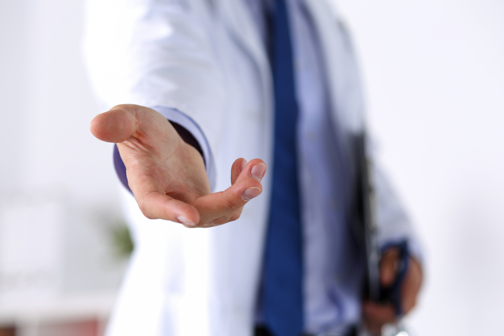 Physician with outstretched hand