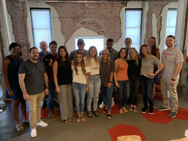 The AcrobatAnt crew smiling together inside the office.