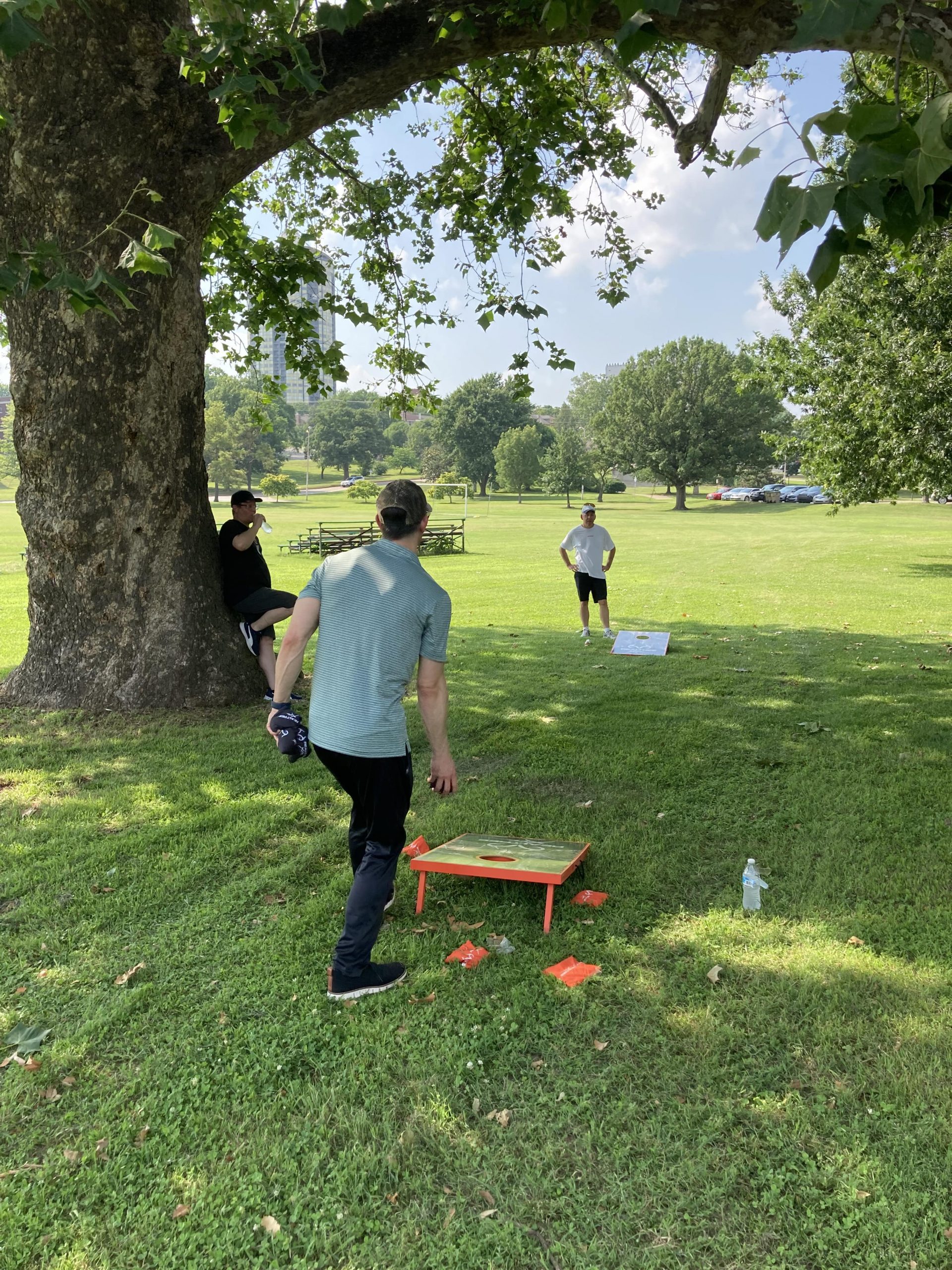Two men playing a game at a park.