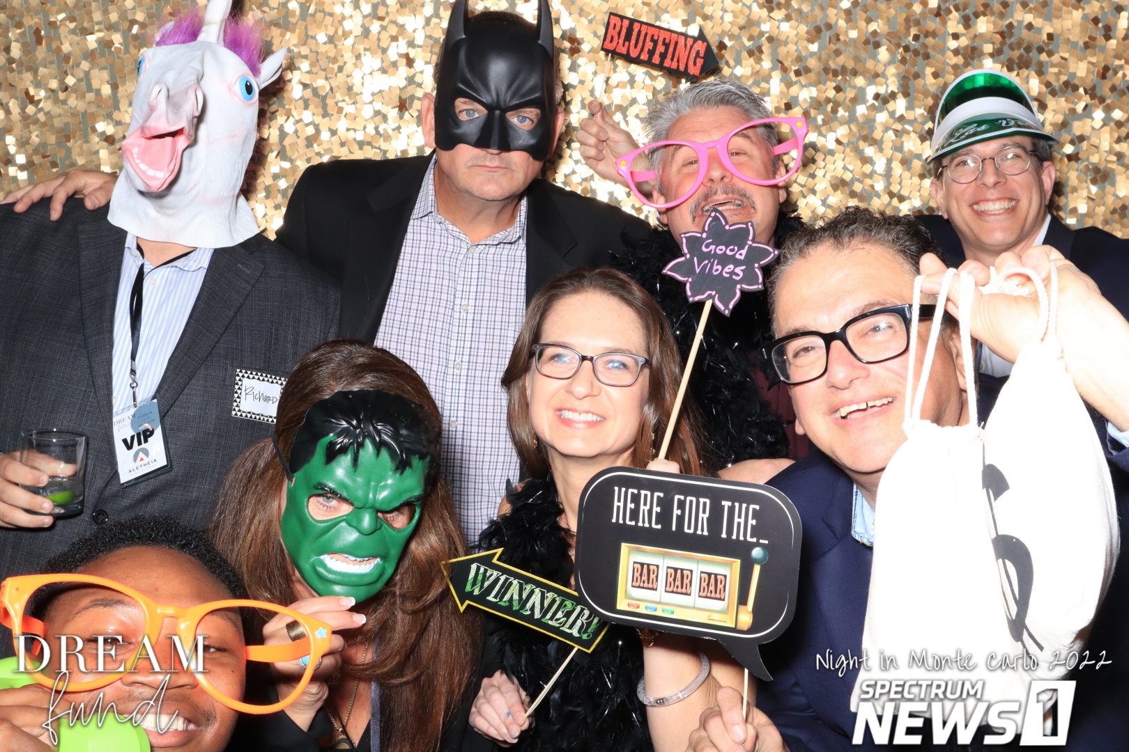 Angela and folks from Aletheia goofing off in a photo booth with silly props and masks.